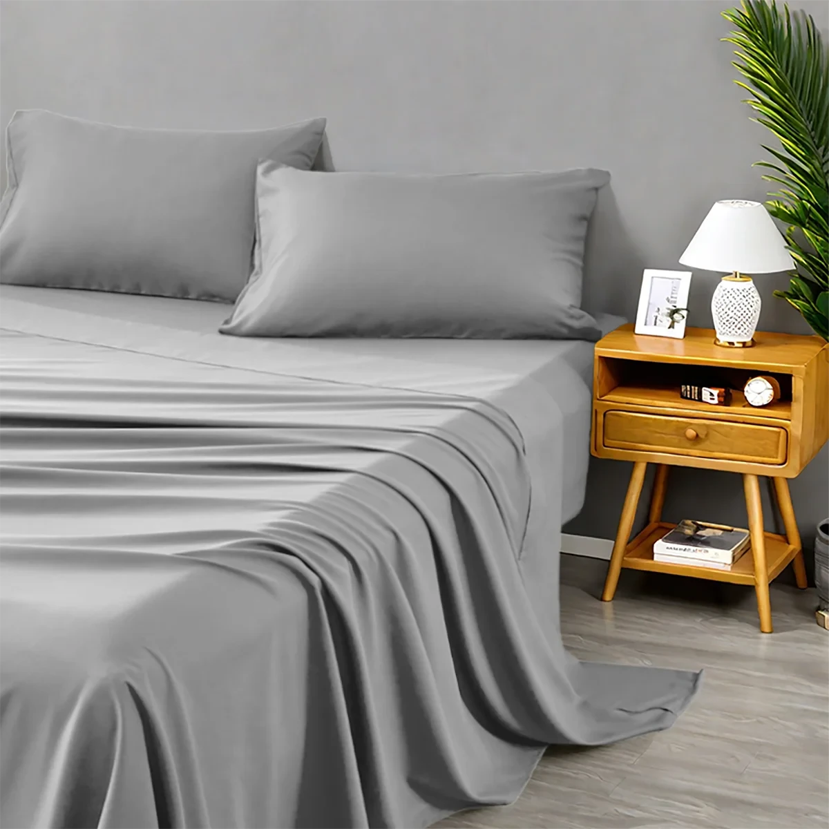 Gray bed sheets and pillows on a bed with a wooden nightstand in a bedroom
setting.
4-piece microfiber bed set
Solid color comforter set
All-season bedding set
Lightweight comforter
Ultra-soft bed sheets
Minimalist bedding set
High thread count sheets
Fade-resistant microfiber bedding
Modern home bedding set