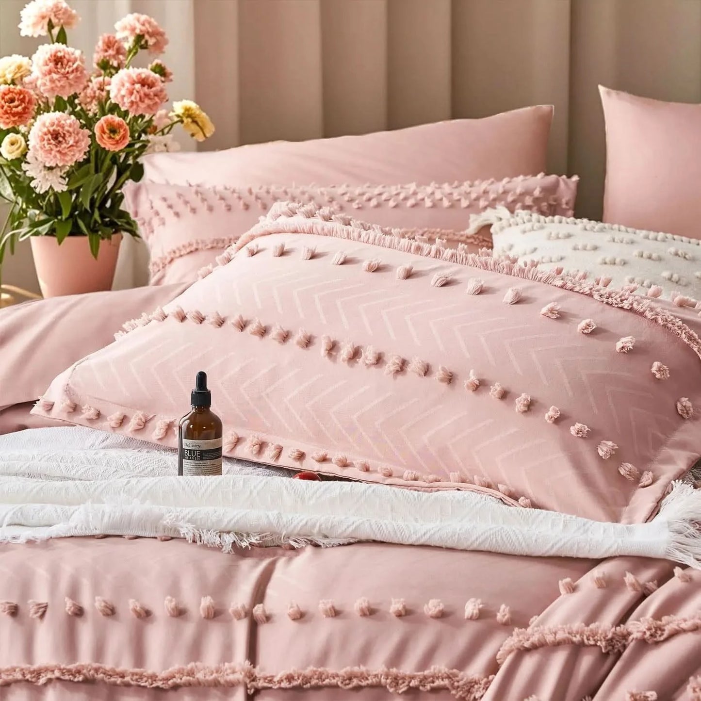 Pink textured bedding set with a bottle of serum on a bed, accompanied by a vase of flowers.
Queen size bedding set
Tufted comforter set
Microfiber bed set
Luxury bedding gift
All-season quilt set
Soft and cozy bed set
Hypoallergenic bedding
Easy care bedding
Full queen bed ensemble