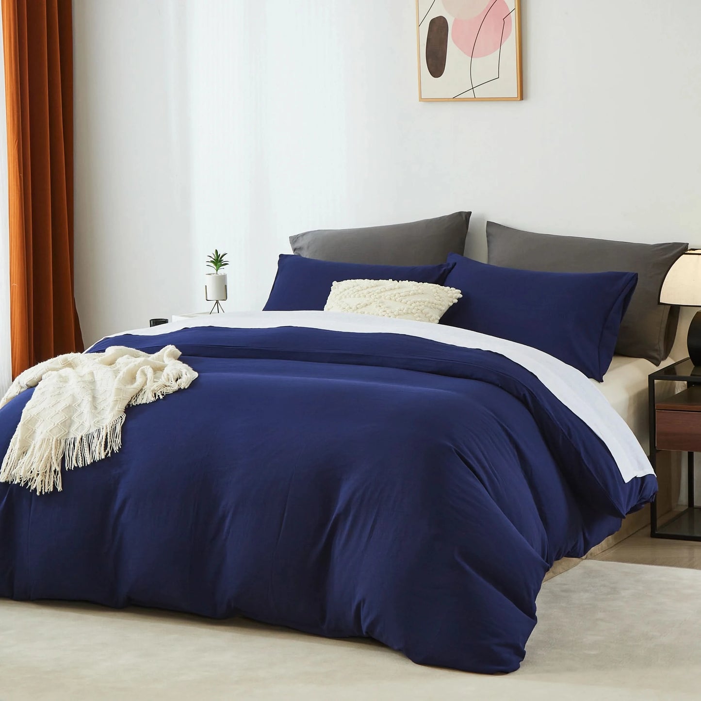 Bed with navy blue bedding and gray pillows in a room with a painting on the wall.
Microfiber Bedding Set, Queen Comforter Set, Lightweight Comforter, Pinch Pleat Bedding, Quilted Comforter, Solid Color Bedding, Soft Bedding Set, Elegant Bedding, All Season Comforter, Brushed Microfiber, Modern Bedroom Decor, Gift Bedding Set, Fade Resistant Bedding, Cozy Bedding Set, Hotel Style Bedding, Bedroom Essentials, Bed Comforter with Pillowcases, Non-Toxic Bedding, Machine Washable Bedding, Minimalist Bedding