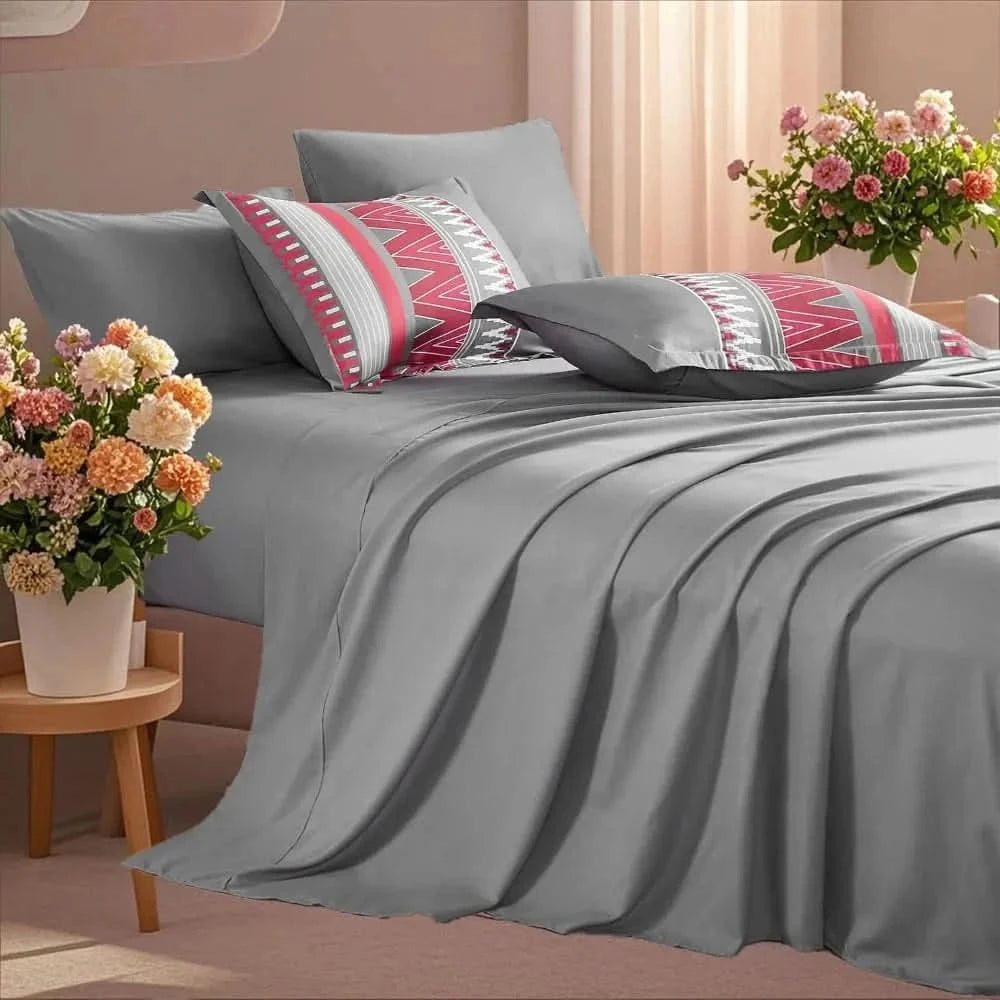 Gray bedding set with patterned pillows on a bed in a bedroom setting.

7-piece microfiber bedding set

All-season bed comforter

Soft brushed microfiber bedding

Luxury quilt set for queen bed

Fade-resistant bedding set

Machine washable comforter set

Elegant bedroom decor

Gift bedding set for women

Hypoallergenic bedding