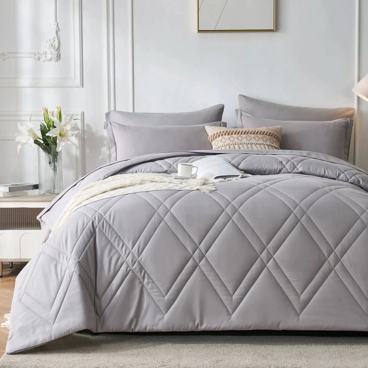 Gray quilted comforter set on a bed in a bedroom setting with pillows and a side table.
Microfiber bedding set

Queen and King bedding

Soft comforter set

Modern bedroom decor

Machine washable bedding

Polyester comforter

Cozy all-season bedding

Brushed microfiber

Lightweight and warm comforter

Bedding set with pillowcases