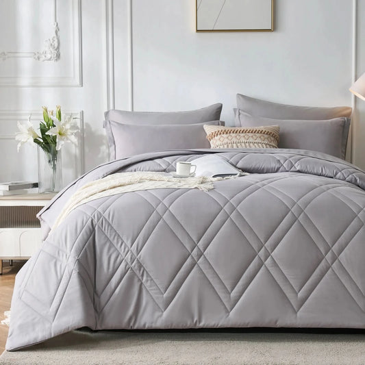 Gray quilted comforter set on a bed in a bedroom setting with pillows and a side table.
Microfiber bedding set

Queen and King bedding

Soft comforter set

Modern bedroom decor

Machine washable bedding

Polyester comforter

Cozy all-season bedding

Brushed microfiber

Lightweight and warm comforter

Bedding set with pillowcases