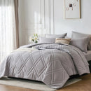 Gray quilted comforter on a bed in a well-lit bedroom
Microfiber bedding set

Queen and King bedding

Soft comforter set

Modern bedroom decor

Machine washable bedding

Polyester comforter

Cozy all-season bedding

Brushed microfiber

Lightweight and warm comforter

Bedding set with pillowcases