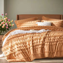 Bed with textured peach-colored bedding and pillows, next to a vase of flowers on a wooden surface.
Queen size bedding set

Tufted comforter set

Microfiber bed set

Luxury bedding gift

All-season quilt set

Soft and cozy bed set

Hypoallergenic bedding

Easy care bedding

Full queen bed ensemble