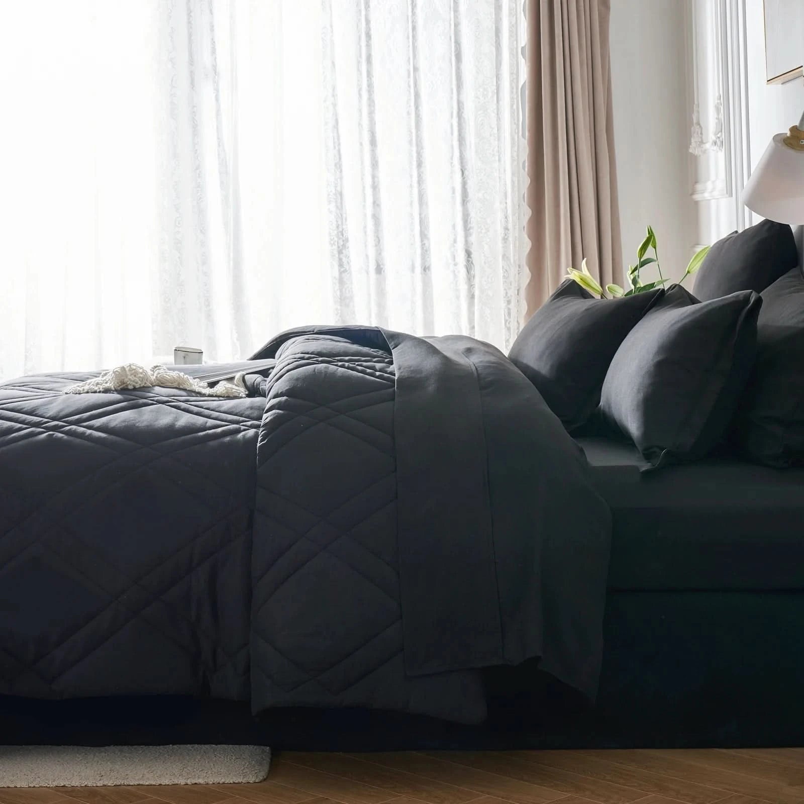 Dark gray comforter and pillows on a bed in a bedroom with light curtains.
Microfiber bedding set

Queen and King bedding

Soft comforter set

Modern bedroom decor

Machine washable bedding

Polyester comforter

Cozy all-season bedding

Brushed microfiber

Lightweight and warm comforter

Bedding set with pillowcases
