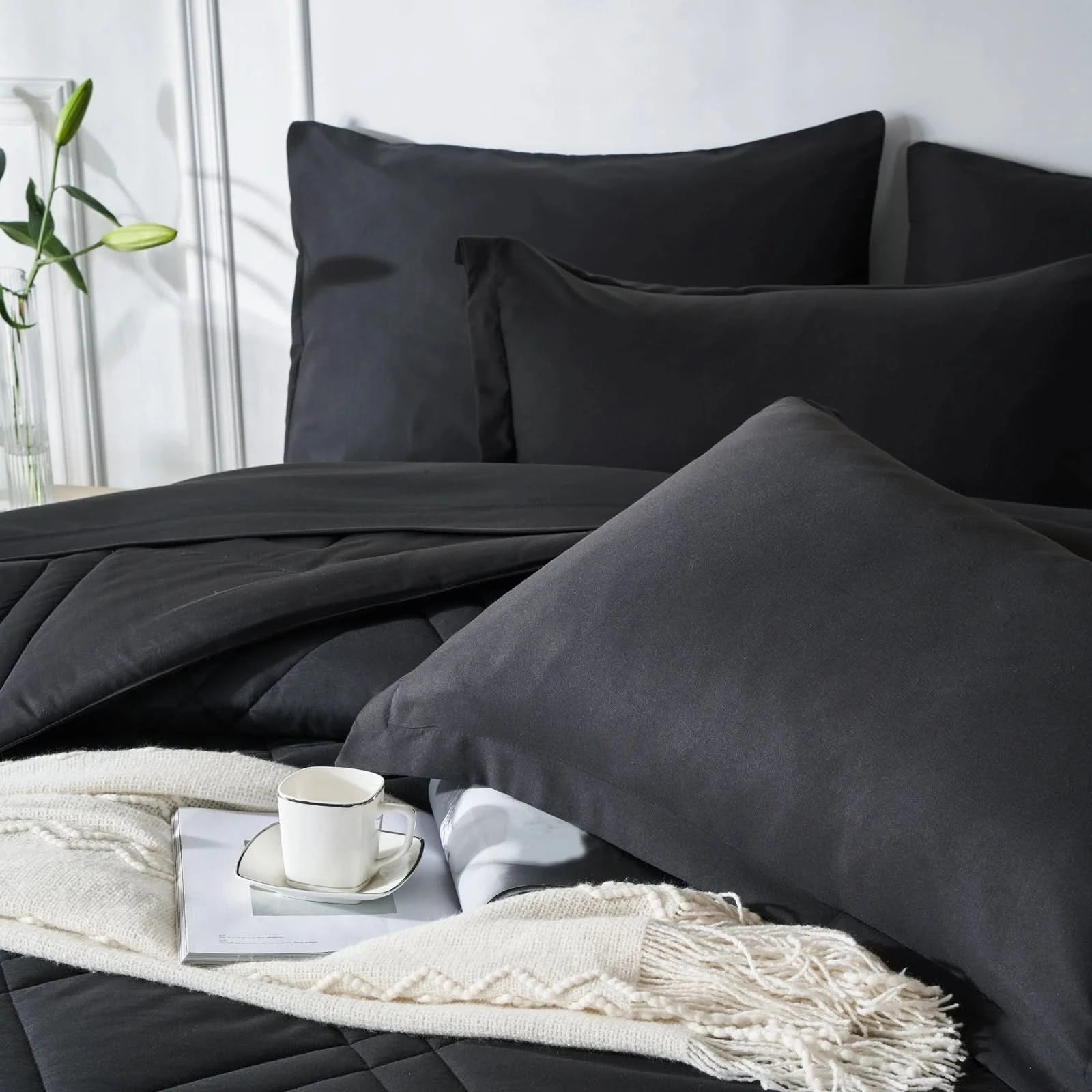 Black bedding set with a white blanket and cup on a bed in a bedroom setting.
Microfiber bedding set

Queen and King bedding

Soft comforter set

Modern bedroom decor

Machine washable bedding

Polyester comforter

Cozy all-season bedding

Brushed microfiber

Lightweight and warm comforter

Bedding set with pillowcases