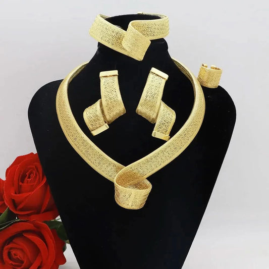 Gold plated spiral necklace, simple earrings, and bracelet set displayed elegantly with roses; women's jewelry set.