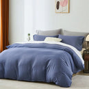 Blue bedding set on a bed in a bedroom with a plant and lamp in the 
Microfiber Bedding Set, Queen Comforter Set, Lightweight Comforter, Pinch Pleat Bedding, Quilted Comforter, Solid Color Bedding, Soft Bedding Set, Elegant Bedding, All Season Comforter, Brushed Microfiber, Modern Bedroom Decor, Gift Bedding Set, Fade Resistant Bedding, Cozy Bedding Set, Hotel Style Bedding, Bedroom Essentials, Bed Comforter with Pillowcases, Non-Toxic Bedding, Machine Washable Bedding, Minimalist Bedding
background.