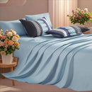 Blue bedding set with decorative pillows and flowers in a bedroom 
7-piece microfiber bedding set

All-season bed comforter

Soft brushed microfiber bedding

Luxury quilt set for queen bed

Fade-resistant bedding set

Machine washable comforter set

Elegant bedroom decor

Gift bedding set for women

Hypoallergenic beddingsetting