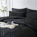 Black quilted comforter set on a bed with pillows and a side table in a 
Microfiber bedding set

Queen and King bedding

Soft comforter set

Modern bedroom decor

Machine washable bedding

Polyester comforter

Cozy all-season bedding

Brushed microfiber

Lightweight and warm comforter

Bedding set with pillowcases bedroom.