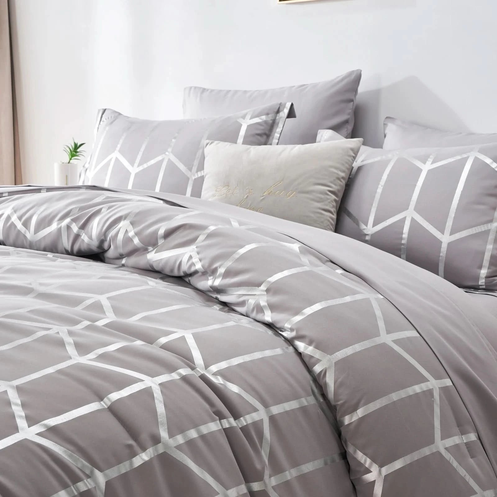 Gray geometric patterned bedding set on a bed with pillows.