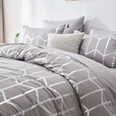 Gray geometric patterned bedding set on a bed with pillows.